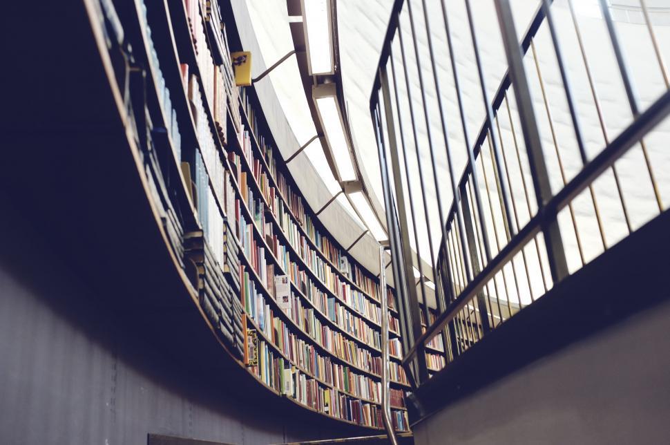 Free Image of Library Interior Filled With Books Next to Metal Fence 