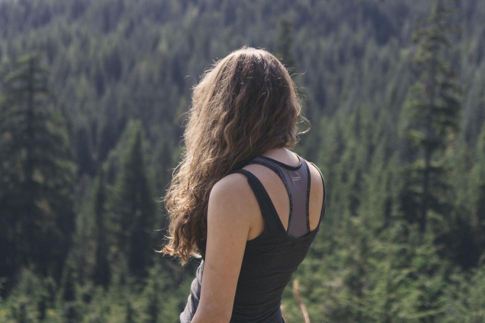 Free Image of Woman Standing in Front of Forest 