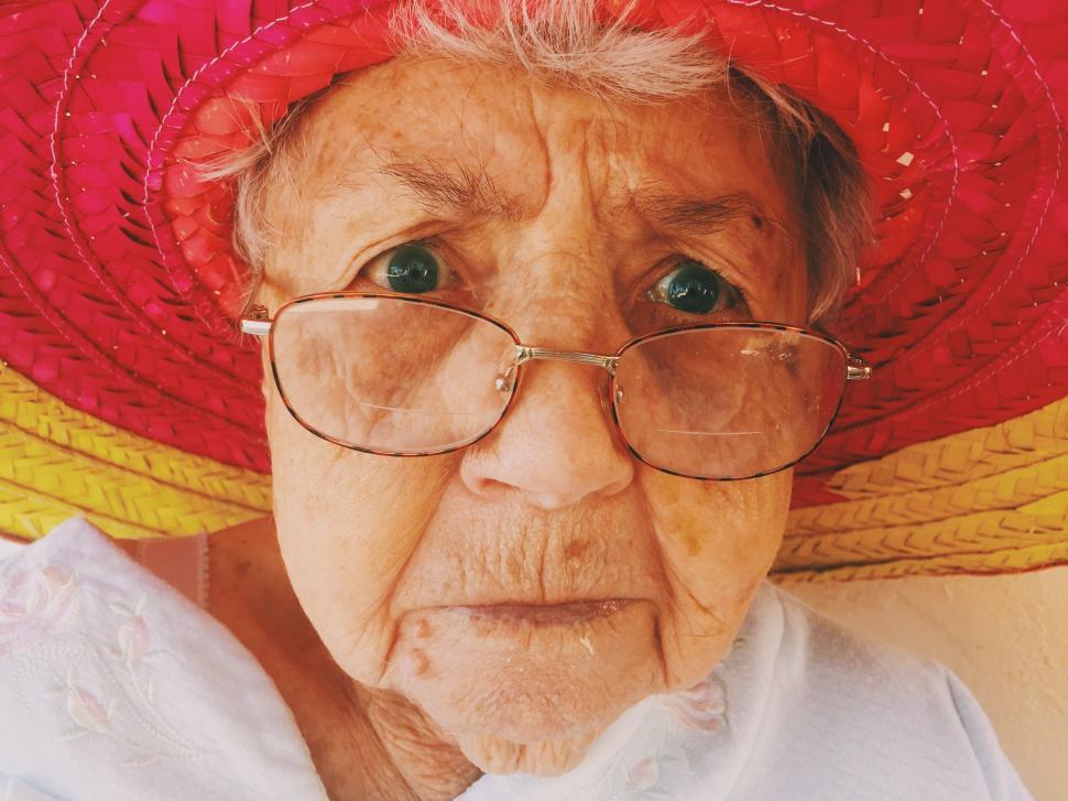 Free Image of Old Woman in Red Hat and Glasses 
