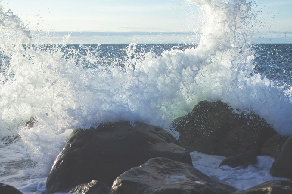 Free Image of Wave Crashing Over Rocks on the Ocean 