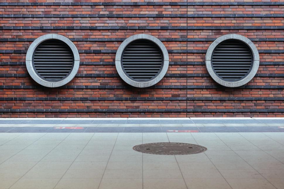 Free Image of Brick Wall With Three Round Windows 