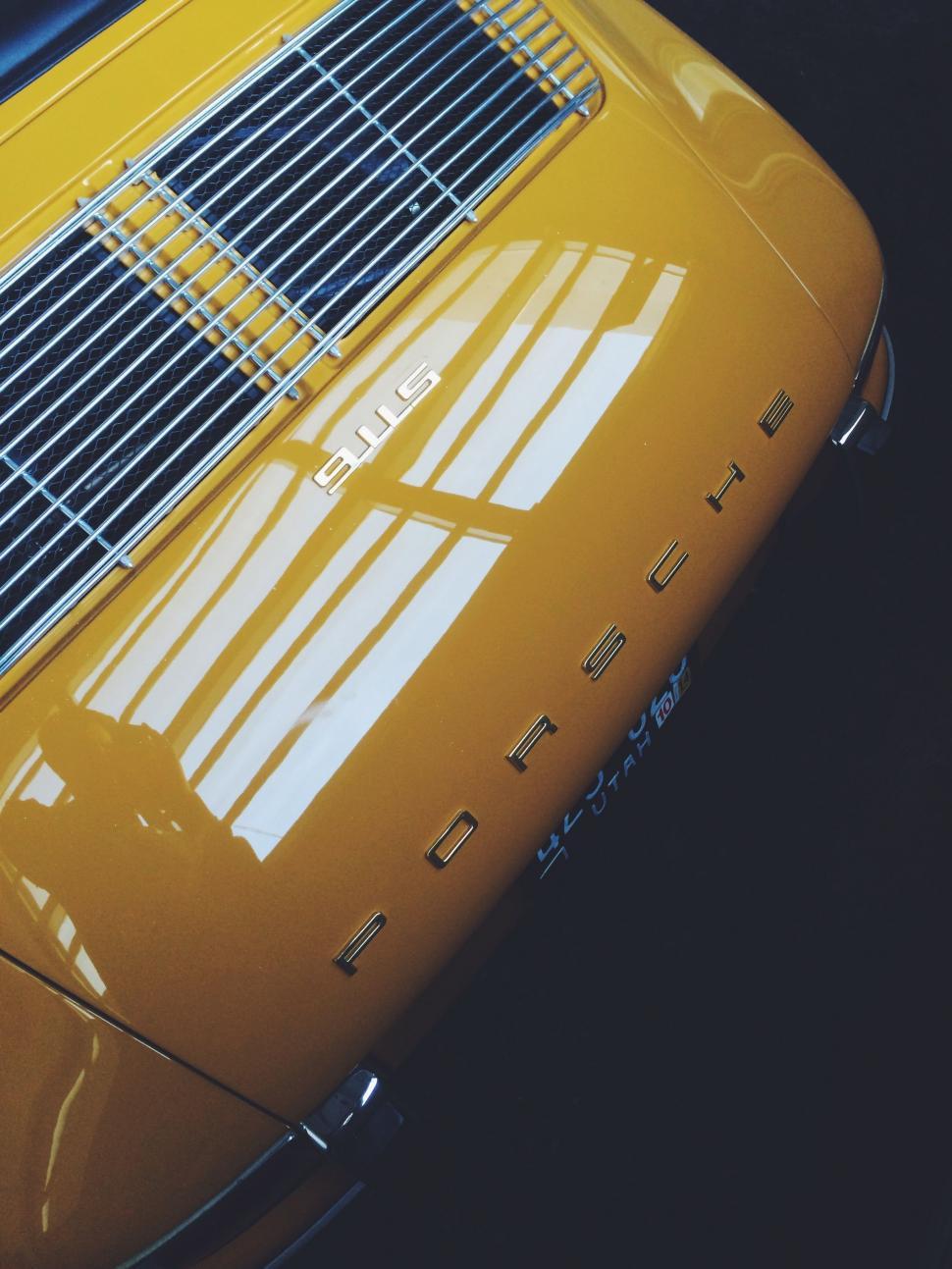 Free Image of Close Up of the Hood of a Yellow Sports Car 