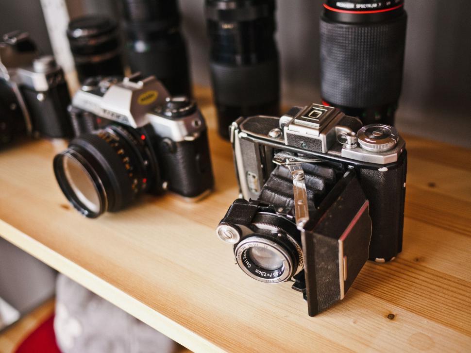 Free Image of Assorted Cameras Displayed on Wooden Table 