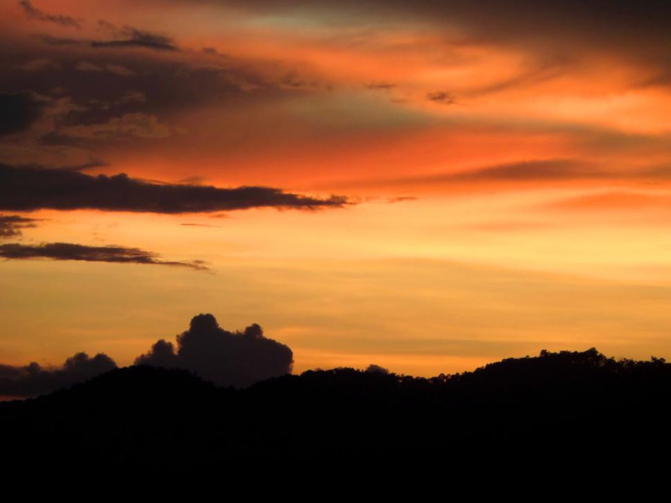 Free Image of sunset sky over silhouetted hills  