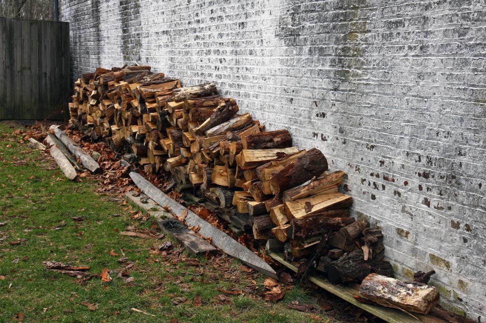 Free Image of Woodpile Against The Side Of A House 
