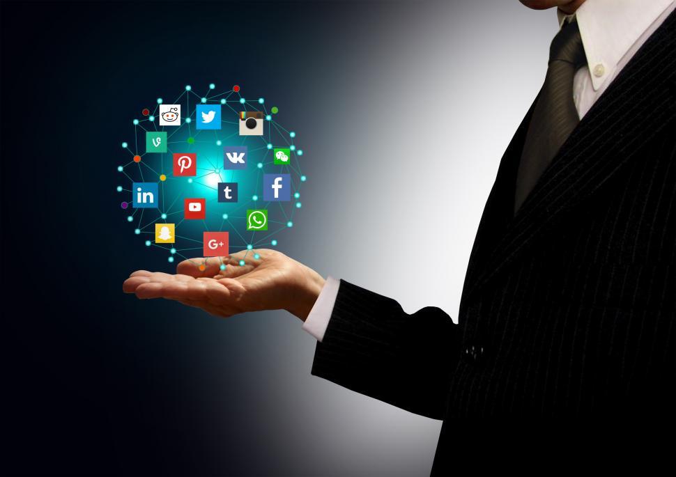 Free Image of Businessman holding hologram with social media network icons 