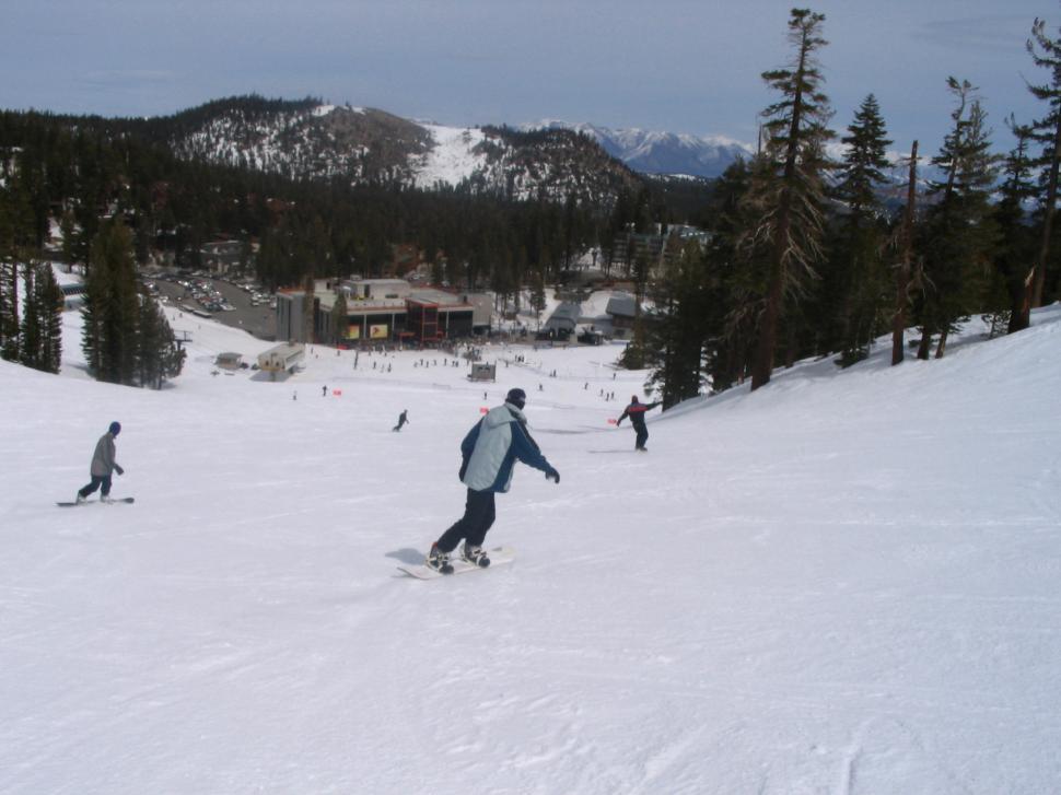 Free Image of Man Snowboarding Down Snow Covered Slope 