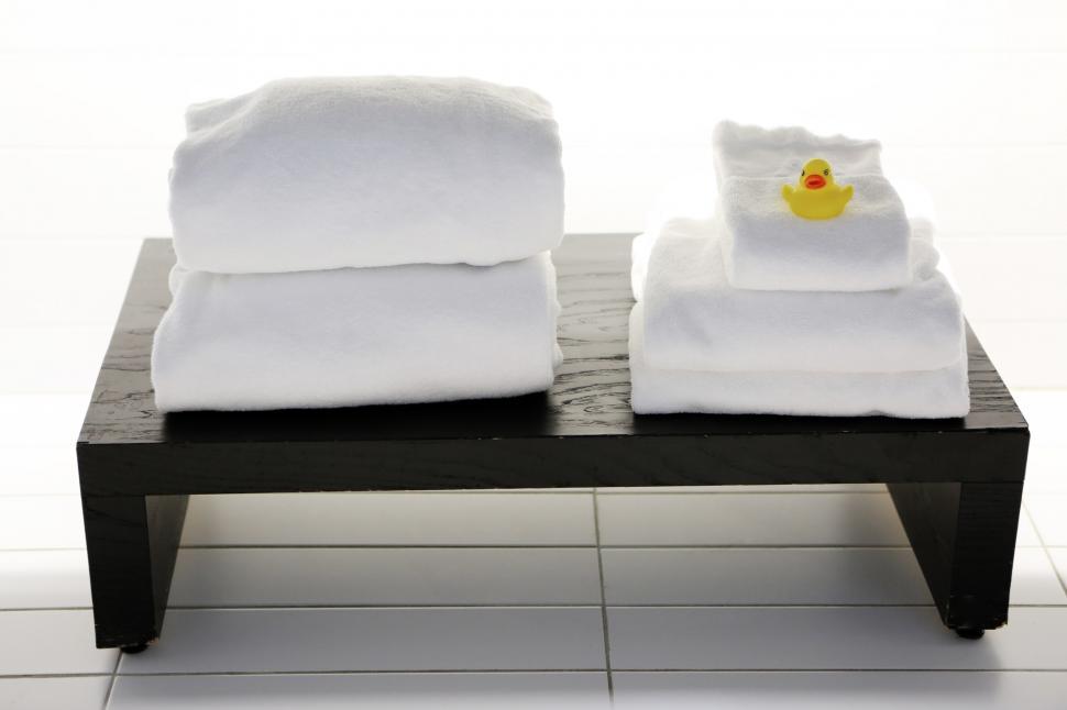 Free Image of Two White Towels on Wooden Table 