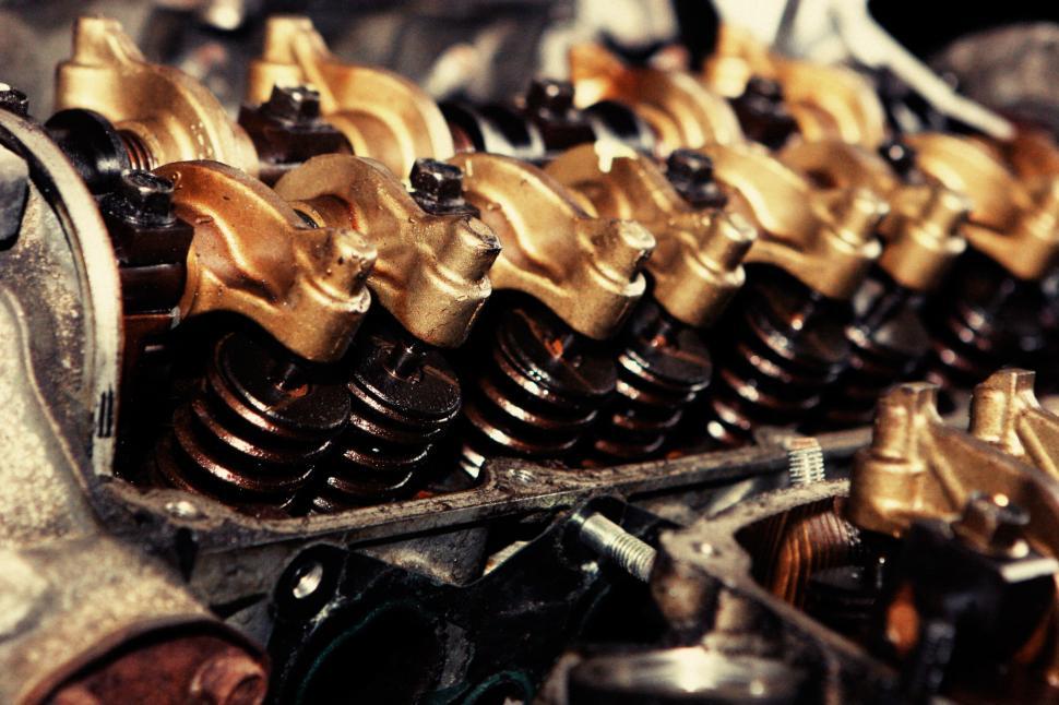 Free Image of Close Up of a Car Engine With Gold and Black Parts 