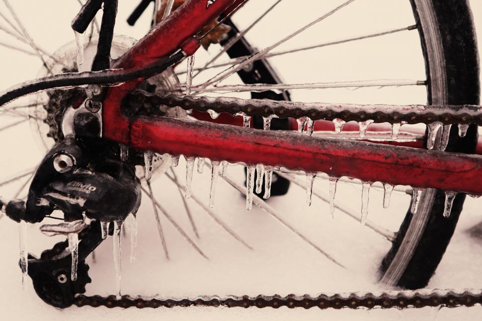 Free Image of Red Bike With Icicles Parked in Snow 