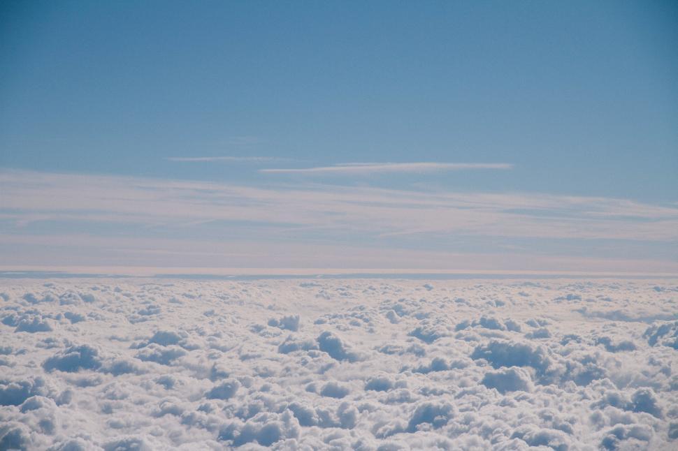Free Image of A Glimpse of Clouds From an Airplane Window 