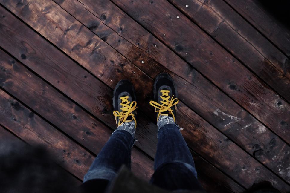 Free Image of Person Standing on Top of Wooden Floor 
