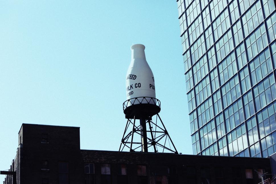 Free Image of Large White Bottle on Top of Building 