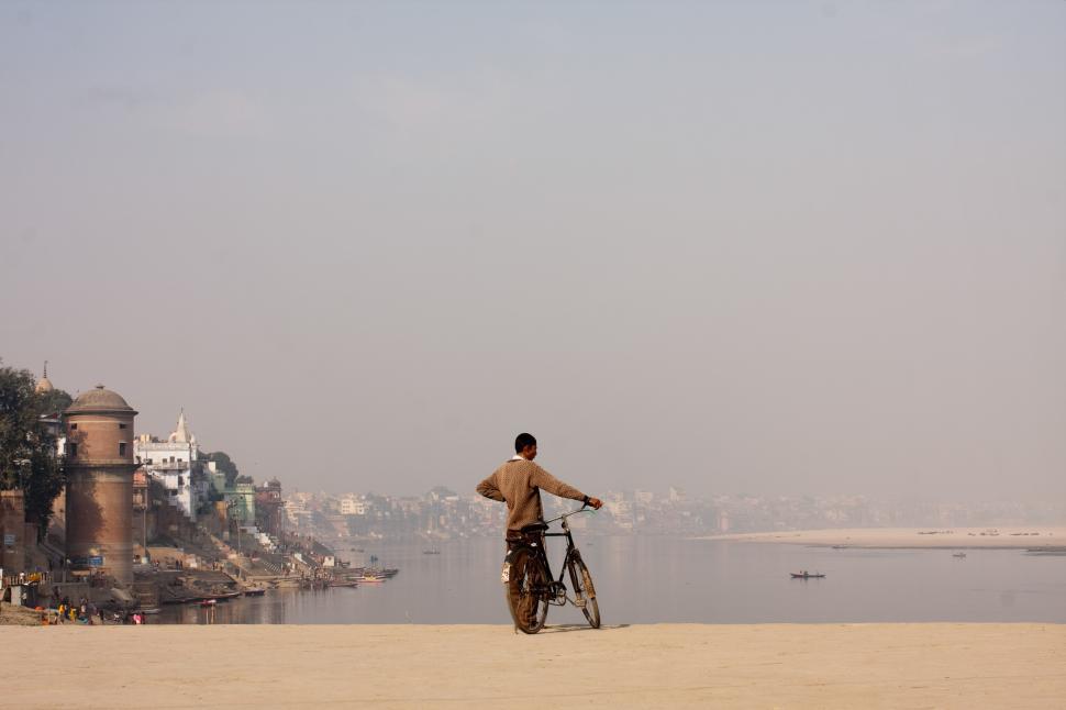 Free Image of Man Riding Bike on Sandy Beach 