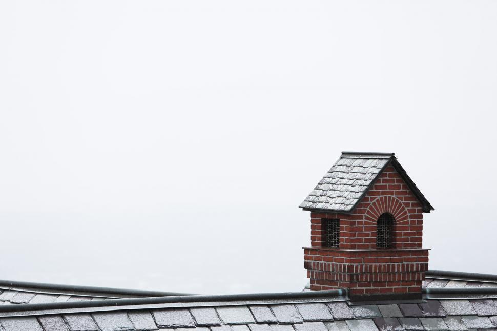 Free Image of Bird Perched on Roof of House 