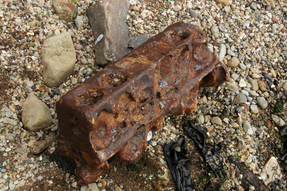 Free Image of Rusted Metal Piece on Rocky Ground 