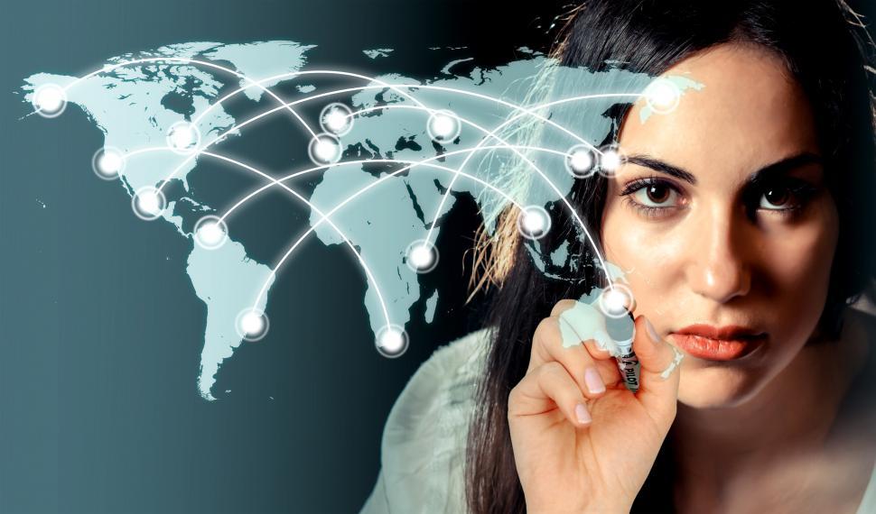 Free Image of Woman drawing a network over a virtual world map 