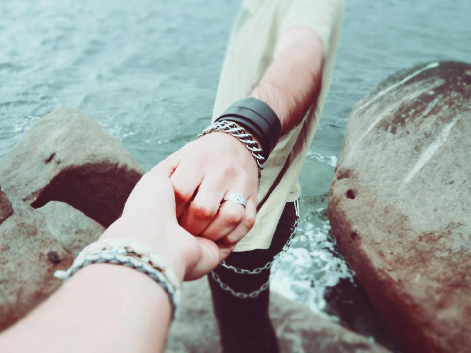Free Image of Couple Holding Hands by Water 
