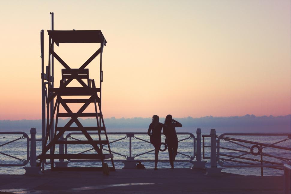 Free Image of People Standing on Top of Pier 