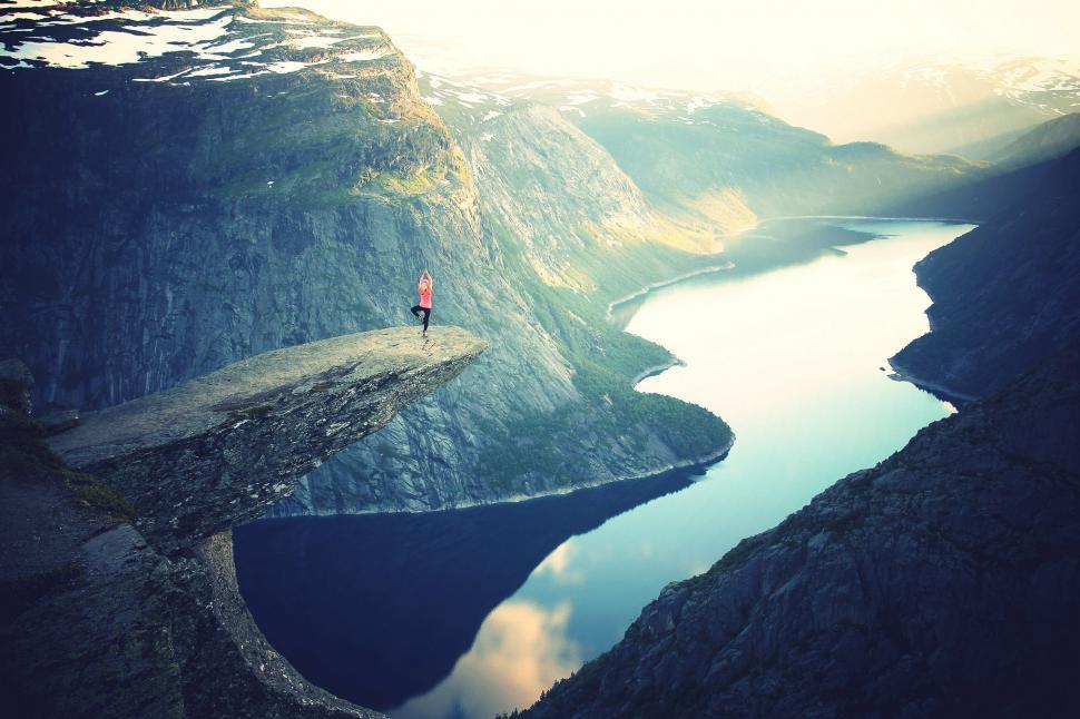 Free Image of Person Standing on Cliff Overlooking Body of Water 