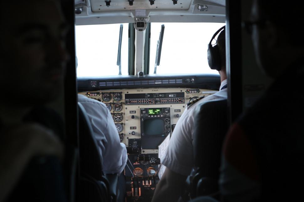 Free Image of Two Pilots Sitting in the Cockpit of an Airplane 