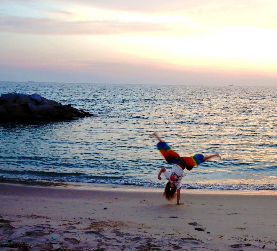 Free Image of Girl does Handstand on the Beach   