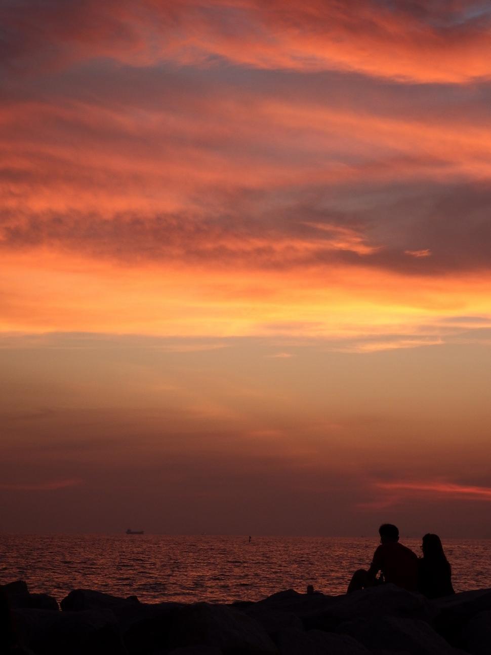 Free Image of Couple Sit and Watch the Sunset  