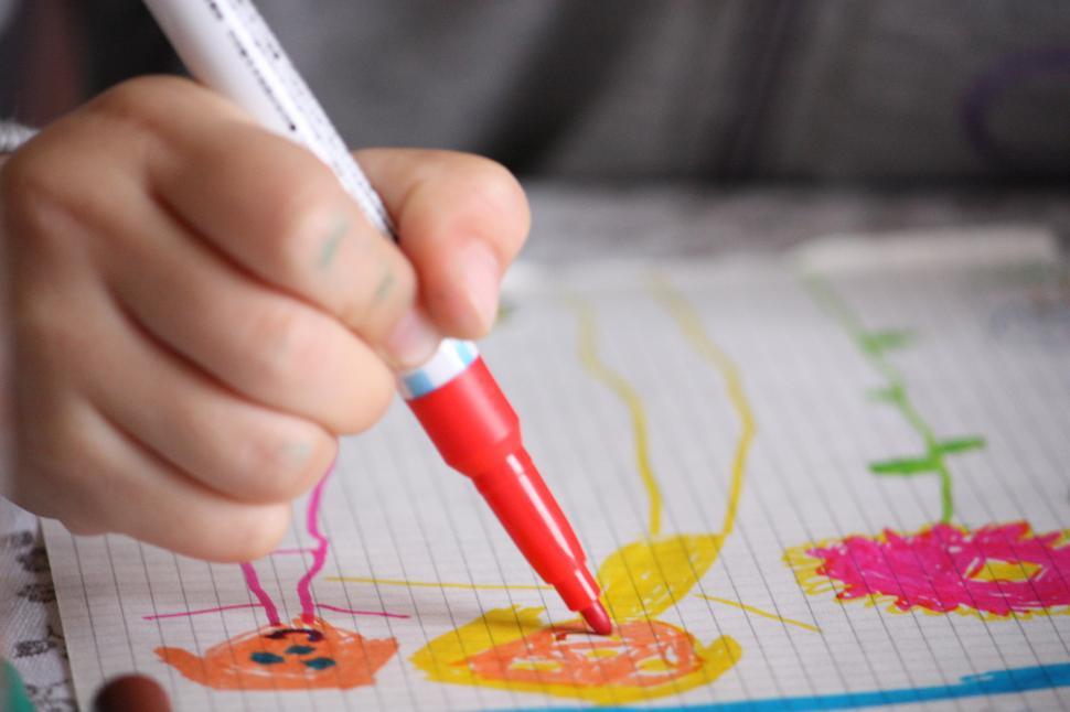 Free Image of Child Drawing on Piece of Paper 