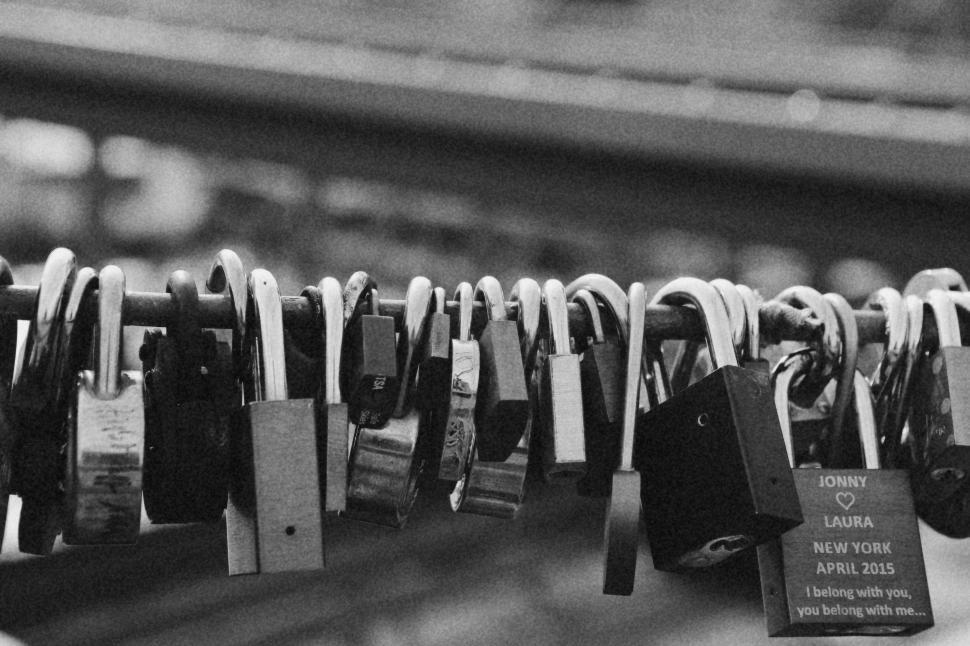 Free Image of Many Padlocks Attached to a Rail 