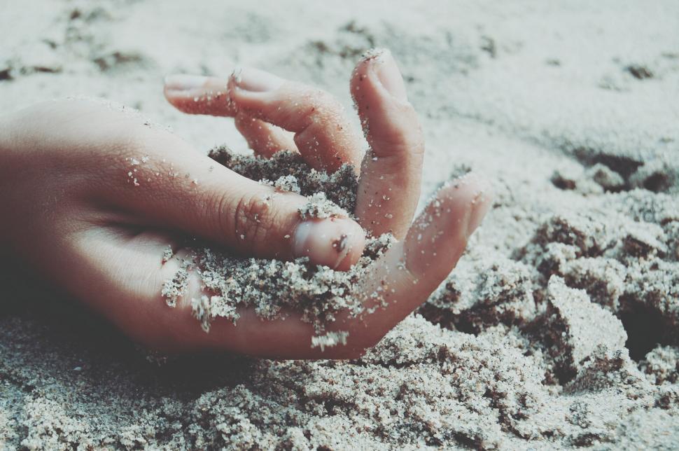 Free Image of Hand Covered in Sand on a Beach 