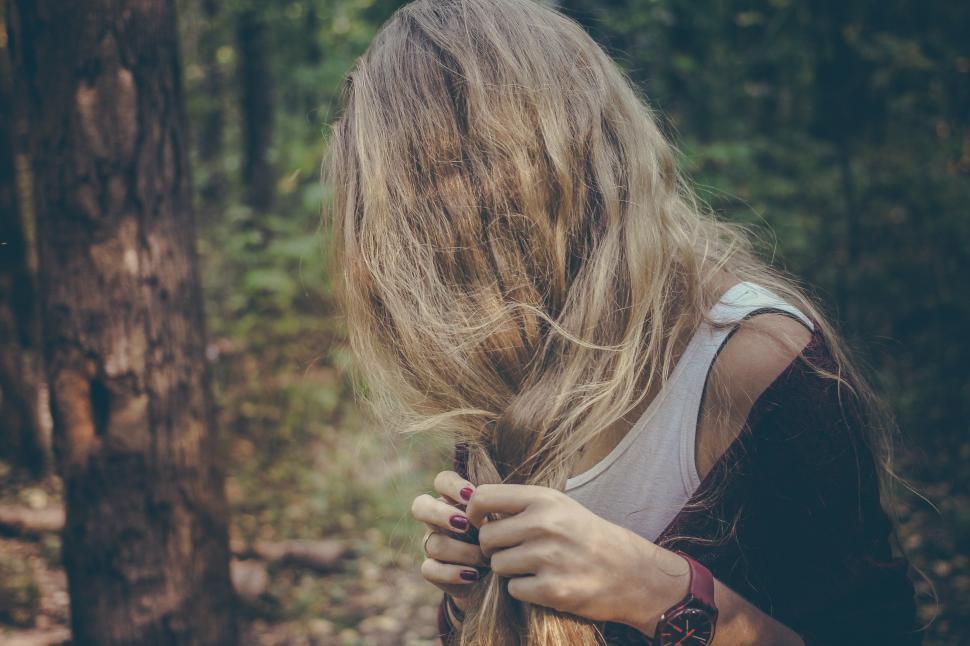 Free Image of Woman With Long Hair Standing in the Woods 