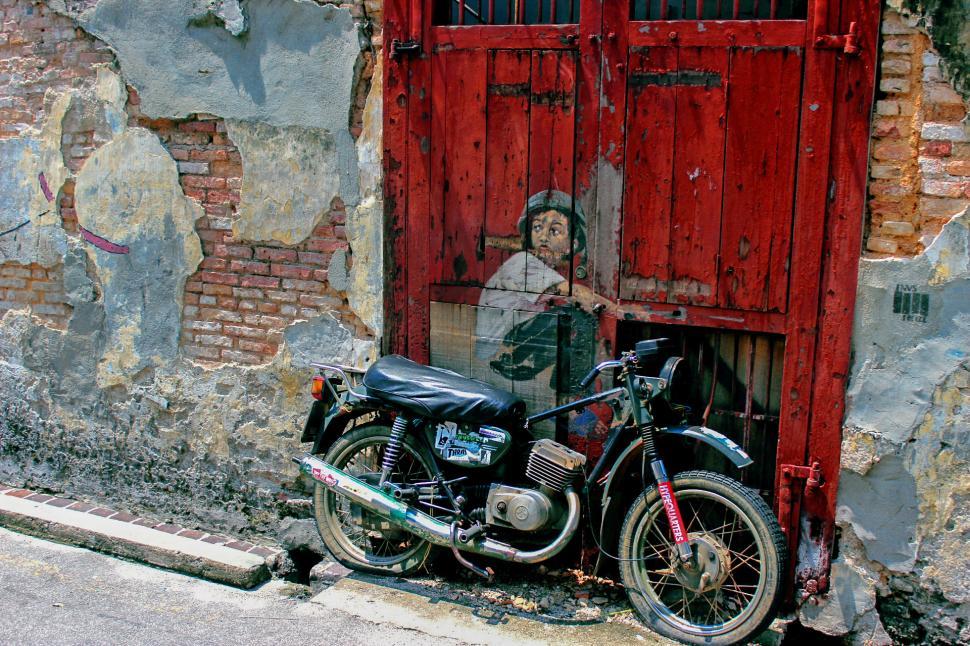 Free Image of Motorcycle Parked in Front of Red Door 