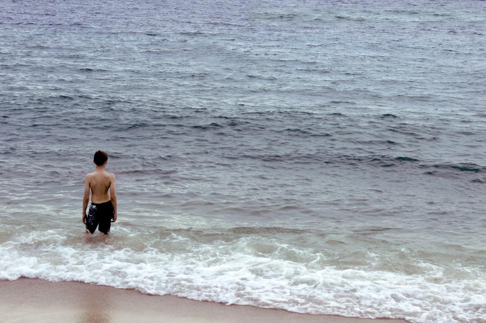 Free Image of Man Standing in Water at Beach 