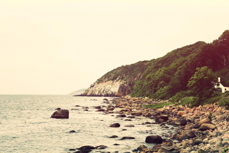 Free Image of Rocky Shoreline Next to Large Body of Water 
