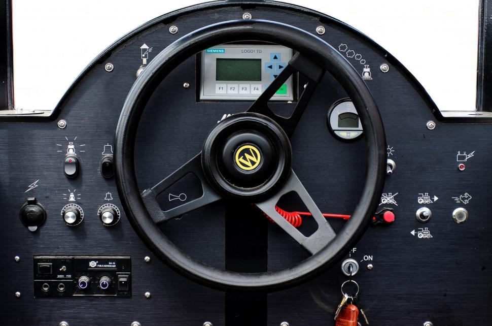 Free Image of Steering Wheel of a Car With Clock 