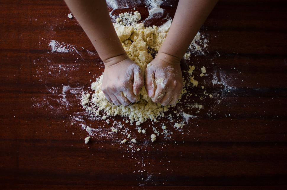 Free Image of Person Kneading Dough on Table 