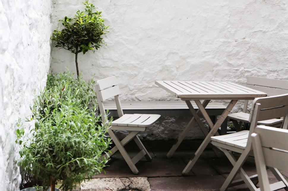 Free Image of Patio With Table, Chairs, and Potted Plant 
