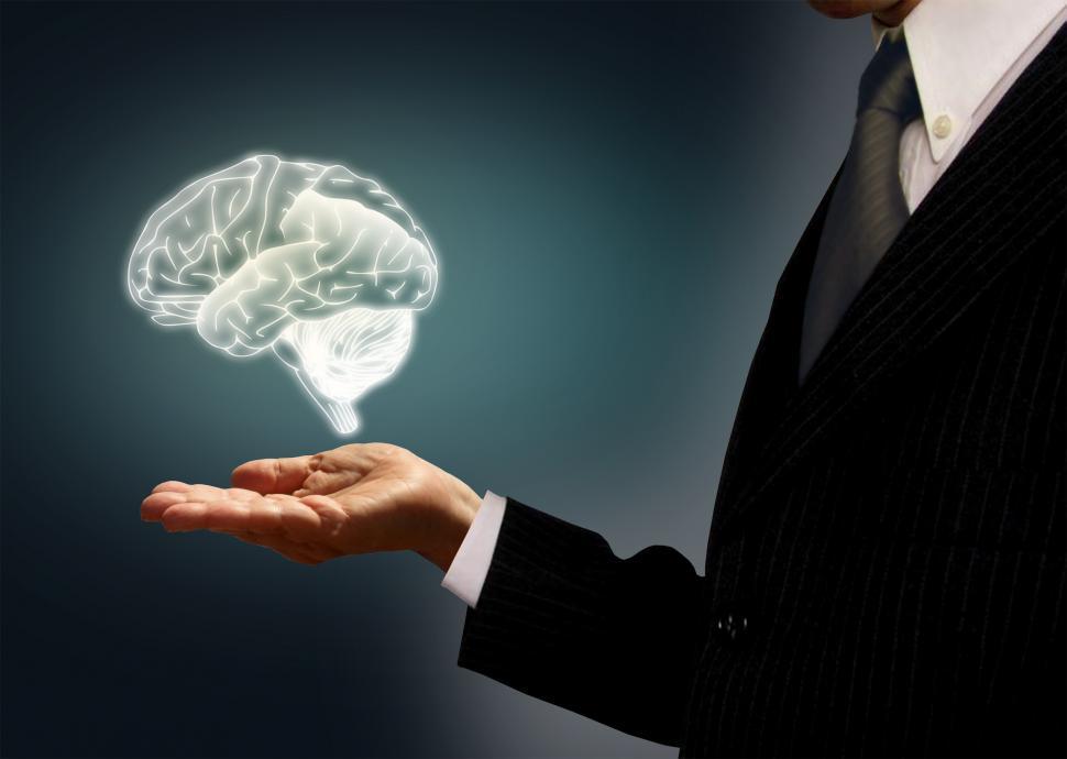 Download Free Stock Photo of Businessman holding a virtual brain in the palm - Skills concept 