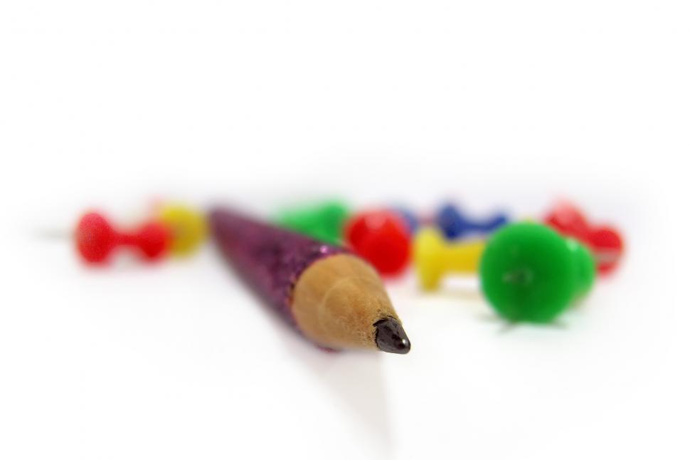 Free Image of Close Up of a Pencil With Colored Crayons in the Background 