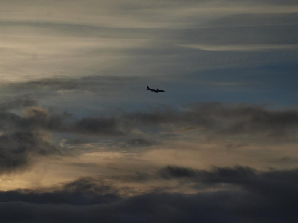 Free Image of Jet Airplane flying in clouds  