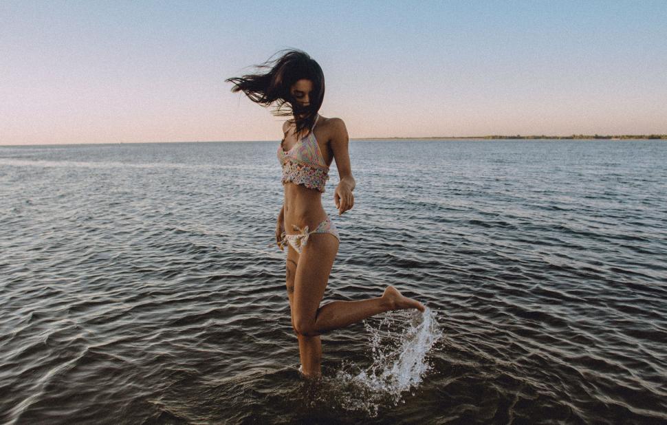 Free Image of Woman in Bikini Jumping Into Water 