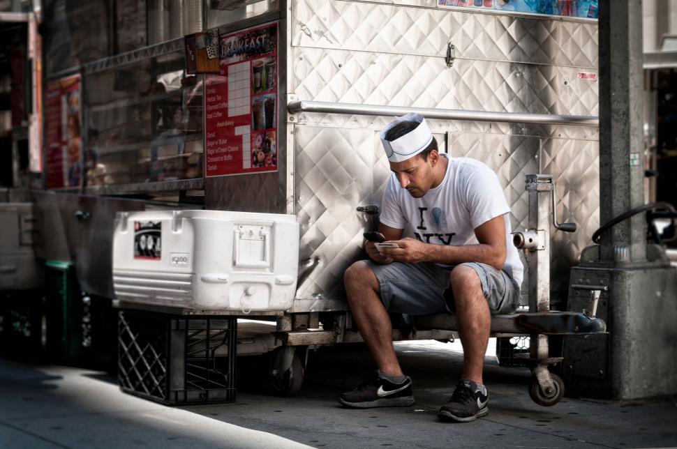 Free Image of Man Sitting on Back of Truck 