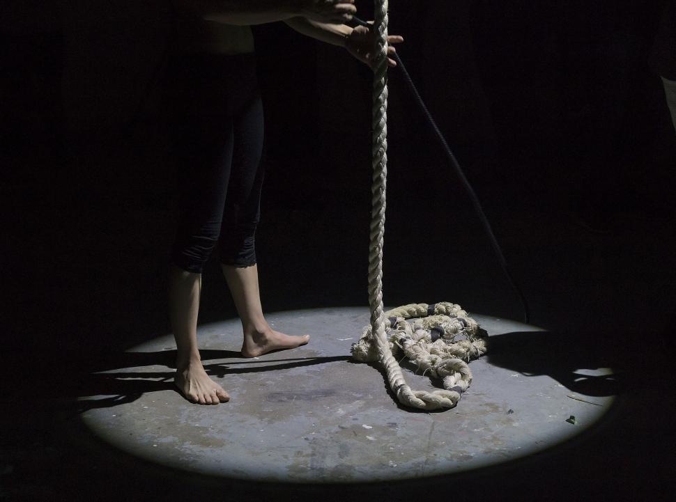 Free Image of Woman Balancing on Rope, Holding Rope 