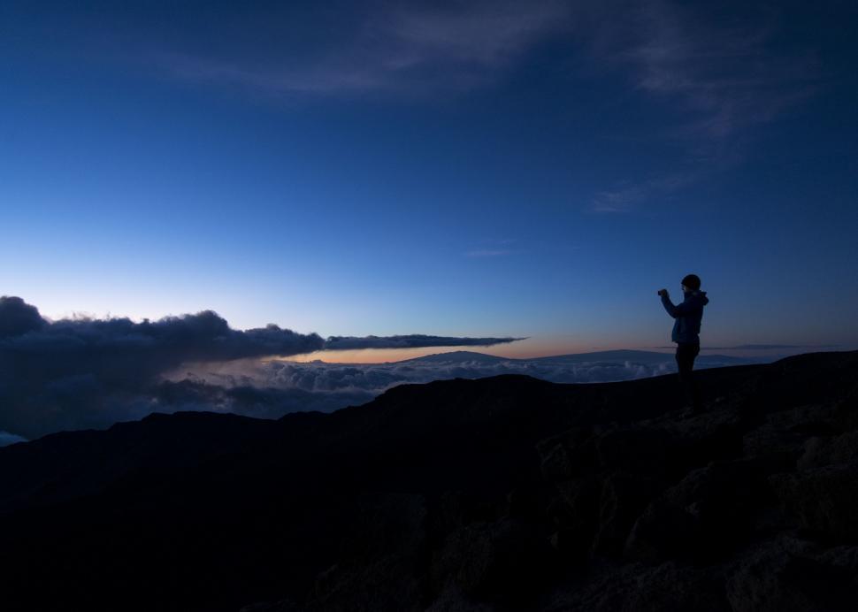 Free Image of Person Standing on Top of Mountain at Night 