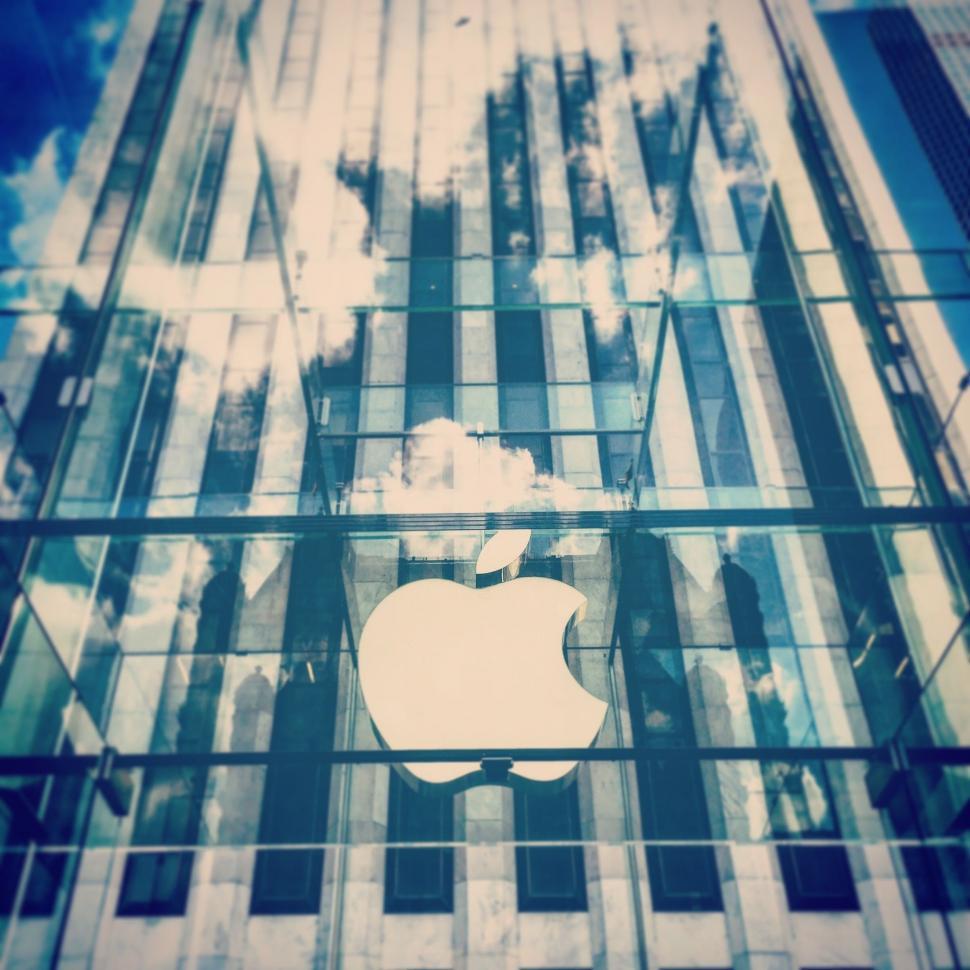 Free Image of Apple Logo Reflecting on Glass Building 