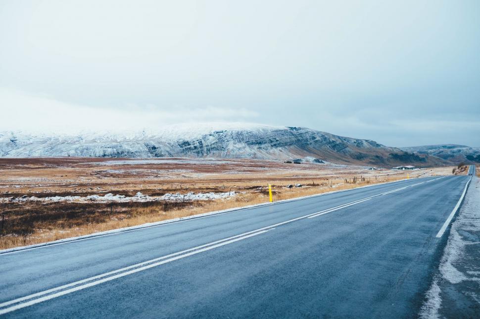 Free Image of Snow Covered Mountains on a Long Road 