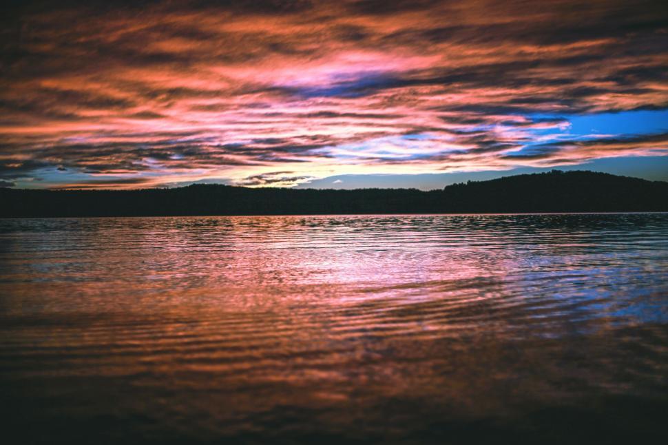 Free Image of Sunset Over Lake With Mountain in Background 