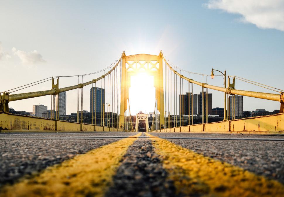 Free Image of The Sun Shines Over a Bridge in the City 