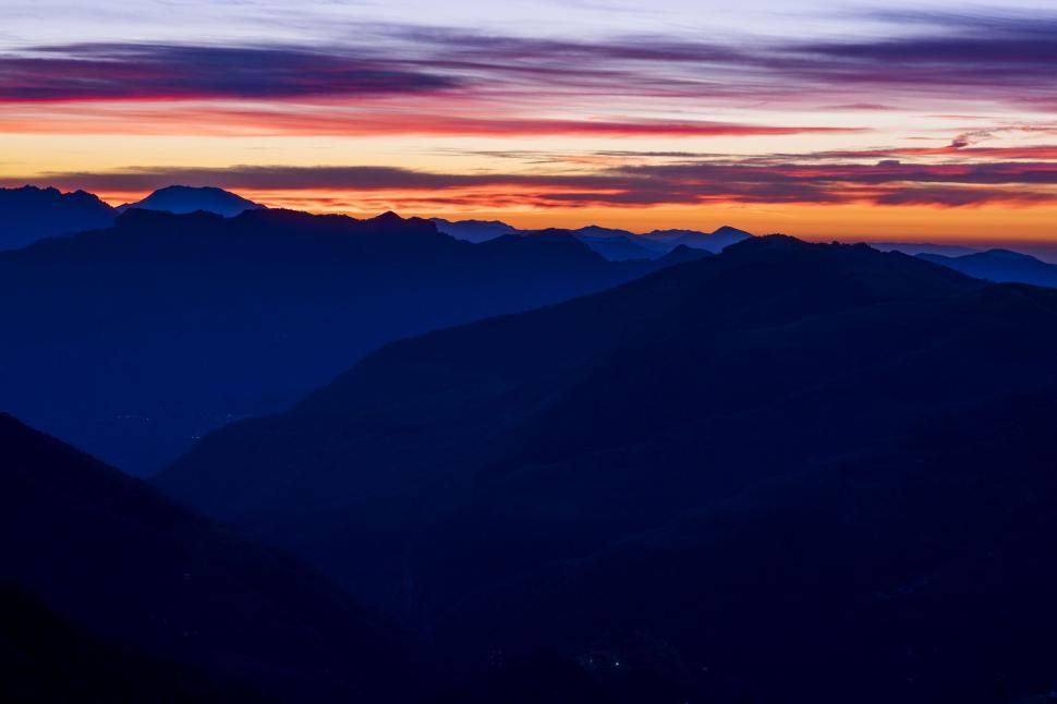 Free Image of Majestic Mountain Range Silhouetted by Sunset 
