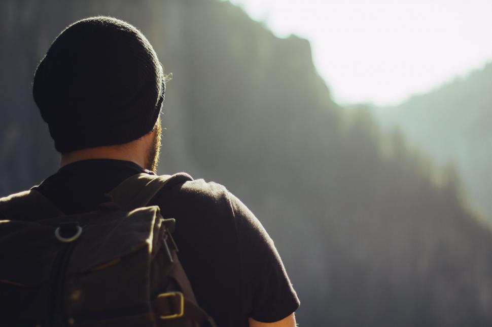 Free Image of Man With Backpack Looking at Mountain 